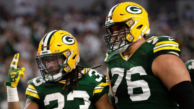 Jon Runyan celebrates a touchdown alongside Aaron Jones.